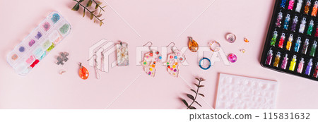 Earrings, pendants and rings made of epoxy resin, mold and sparkles on a pink top view web banner Earrings, pendants and rings made of epoxy resin, mold and sparkles on a pink top view web banner 115831632
