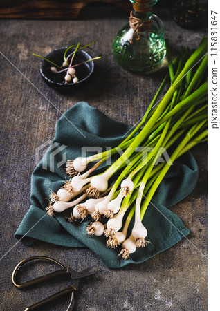 New trendy vegetable sweet garleek on a cloth on the table vertical view 115831647
