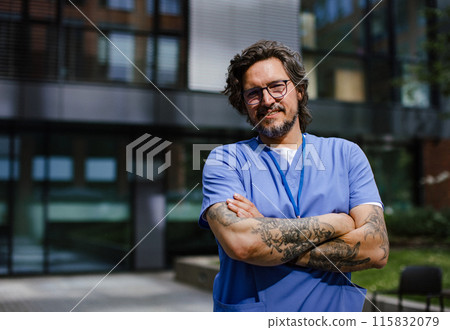 Portrait of handsome doctor in uniform outdoors. Work-life balance of healthcare worker. 115832079