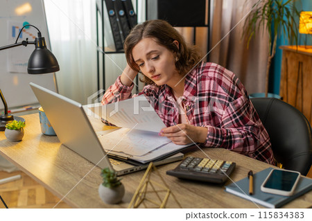 Tired exhausted woman analyzing paperwork graphs accounting payments calculating monthly expenses 115834383