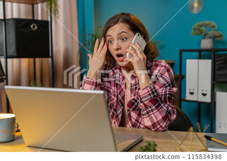Business woman freelancer answering to colleague on mobile phone call using smartphone and laptop Business woman freelancer answering to colleague on mobile phone call using smartphone and laptop 115834398