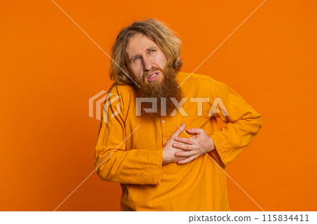 Stressed sick young man suffers from tension holding chest with heart pain attack risk of stroke Stressed sick young man suffers from tension holding chest with heart pain attack risk of stroke 115834411
