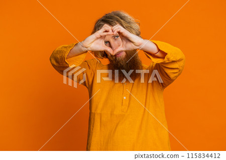 Smiling lovely man makes heart gesture demonstrates love sign expresses good feelings and sympathy 115834412