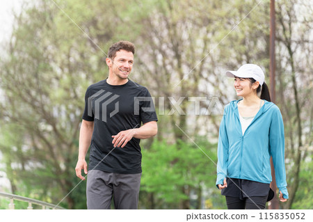 Men and women wearing sportswear walking, strolling and doing aerobic exercise in the park for health Men and women wearing sportswear walking, strolling and doing aerobic exercise in the park for health 115835052