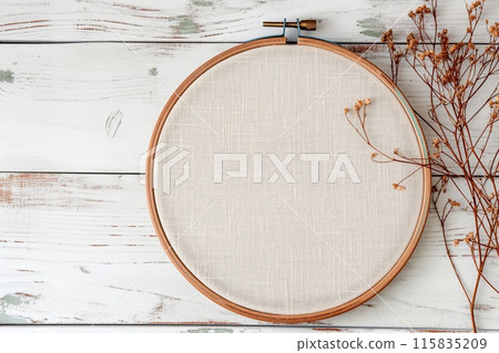 Flat lay composition with embroidery hoop and dried flowers on a light background 115835209