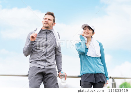 Men and women in sportswear taking a break or interval while jogging or walking in the park Men and women in sportswear taking a break or interval while jogging or walking in the park 115835419