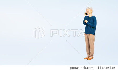 Full-body photo of a senior woman talking on a smartphone 115836136