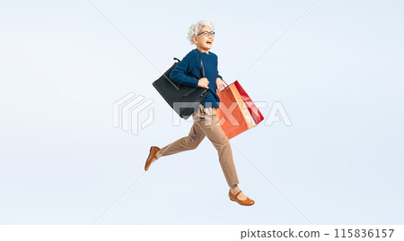 Full body photo of a senior woman jumping with shopping bags Full body photo of a senior woman jumping with shopping bags 115836157