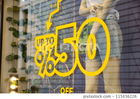 Large Sale text letters on clothing store . 115836226