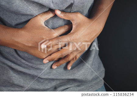 young man suffering stomach pain close up. young man suffering stomach pain close up. 115836234