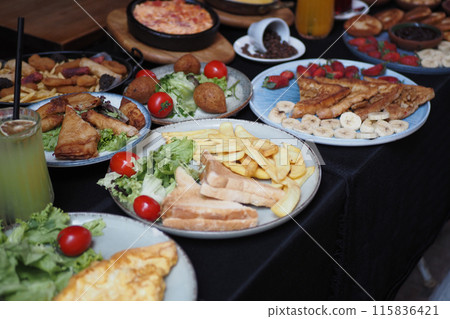 Delicious Spread of Diverse Dishes Including Fresh Salads, Fries, Toasts, and Fresh Juices Delicious Spread of Diverse Dishes Including Fresh Salads, Fries, Toasts, and Fresh Juices 115836421