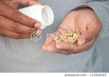 Closeup of herbal medicine capsule on hand  115836423