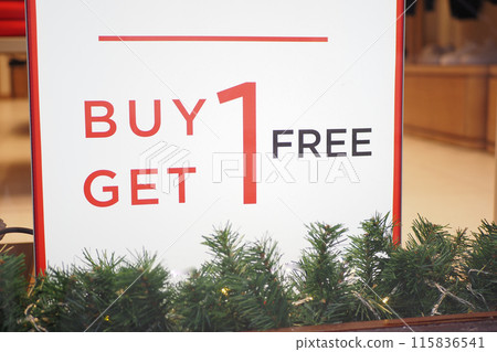 buy one get one free text letters on a glass wall obstruct a view inside the popular fashion store 115836541