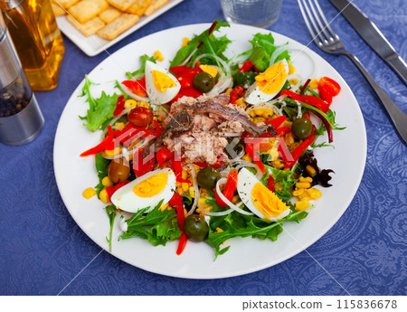Corn, olive, anchovy, pepper, lettuce salad served on plate Corn, olive, anchovy, pepper, lettuce salad served on plate 115836678