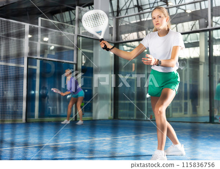 Girl tennis player playing padel tennis 115836756