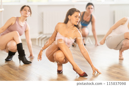 Young woman leading group heels dance class in studio 115837098