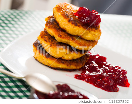 Stack of sweet fried quark pancakes with with tasty berry jam Stack of sweet fried quark pancakes with with tasty berry jam 115837262