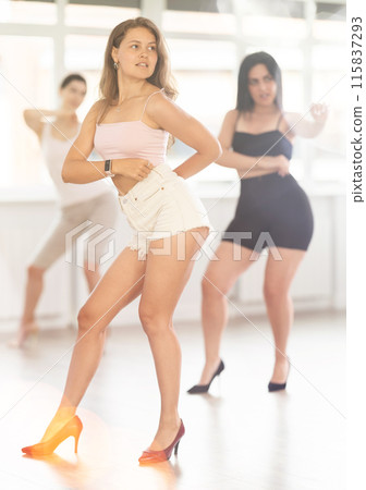 Young woman performing sass dance at group class 115837293