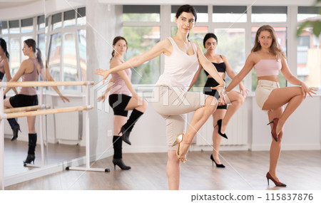 Slim brunette in heels practicing jazz-funk dance in studio 115837876