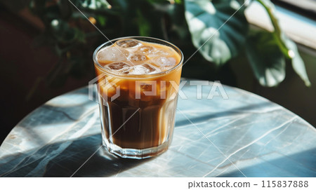 A Glass Of Iced Coffee Is Sitting On A Table 115837888