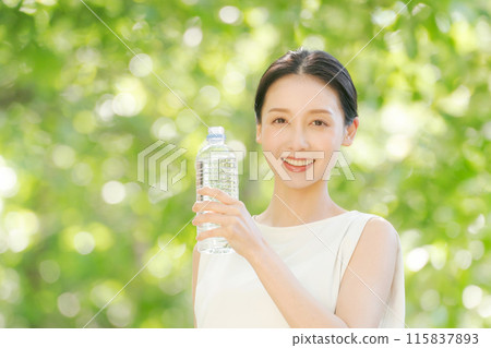 A woman drinking water of a plastic bottle A woman drinking water of a plastic bottle 115837893
