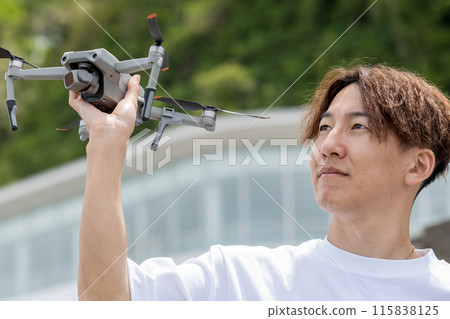 日本男子在陽光明媚的日子在戶外享受無人機攝影 | 無人機影像 115838125