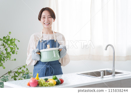 Woman cooking in the kitchen (housework, housewife, cooking for herself) 115838244