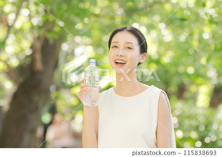 A woman drinking water of a plastic bottle A woman drinking water of a plastic bottle 115838693
