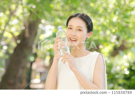 A woman with a bottle of water A woman with a bottle of water 115838789