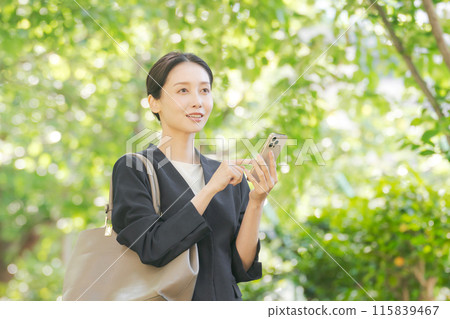 A woman with a suit with a smartphone 115839467