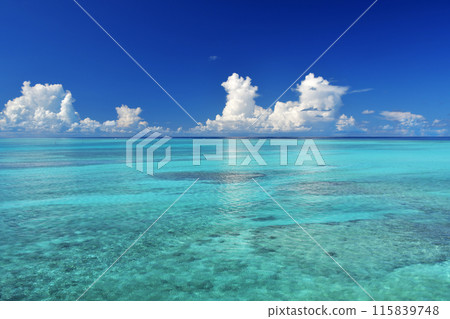A midsummer cumulonimbus cloud and the blue sea of the coral reef seen from Ikema Bridge A midsummer cumulonimbus cloud and the blue sea of the coral reef seen from Ikema Bridge 115839748