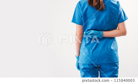 Hoping doctor. Crossed fingers. Unrecognizable female surgeon worrying showing hand gesture behind back expecting successful wish result isolated on white empty space background. Hoping doctor. Crossed fingers. Unrecognizable female surgeon worrying showing hand gesture behind back expecting successful wish result isolated on white empty space background. 115840003