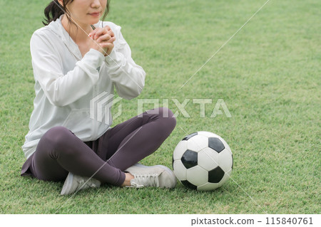 A Japanese woman who is a soccer fan and supporter cheering for the Japan national team as if praying A Japanese woman who is a soccer fan and supporter cheering for the Japan national team as if praying 115840761