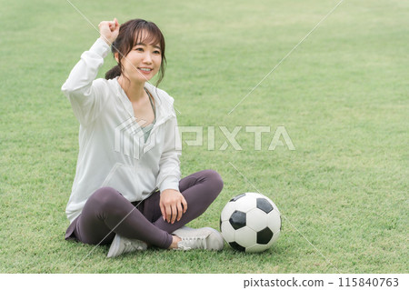 A Japanese woman who is a soccer fan and supporter who wins in soccer and makes a guts pose A Japanese woman who is a soccer fan and supporter who wins in soccer and makes a guts pose 115840763