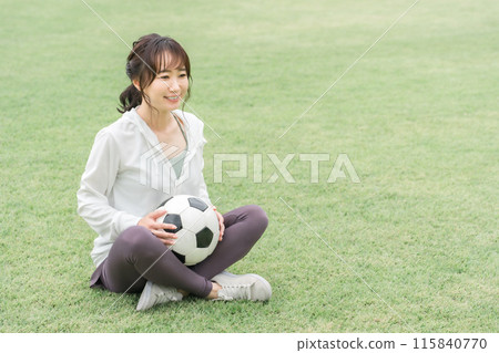 A Japanese woman who is a soccer fan and supporter with a soccer ball on the playground A Japanese woman who is a soccer fan and supporter with a soccer ball on the playground 115840770