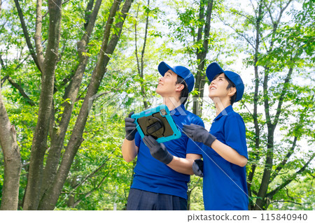 A worker managing a forest looking at a tablet PC 115840940
