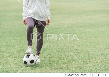 A woman playing soccer and futsal in the park to lose weight and burn calories A woman playing soccer and futsal in the park to lose weight and burn calories 115841101