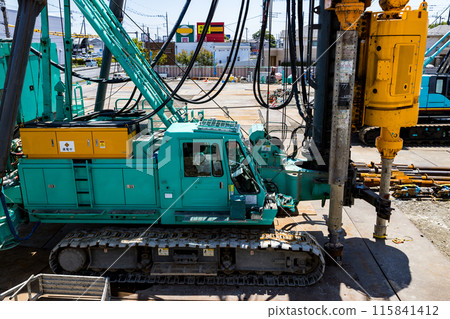 Construction site: Heavy equipment pile driver earth auger Construction site: Heavy equipment pile driver earth auger 115841412