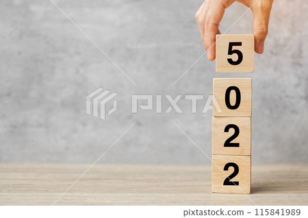 hand holding block 2025 text on table. Resolution, strategy, plan, goal, motivation, reboot, business and New Year holiday concepts 115841989