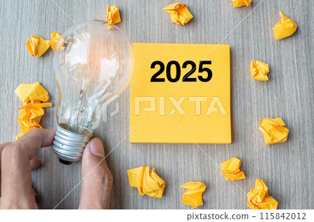 2025 words on yellow note and crumbled paper with Businessman holding lightbulb on wooden table background. New Year New Idea Creative, Innovation, Imagination, Resolution and Goal concept 2025 words on yellow note and crumbled paper with Businessman holding lightbulb on wooden table background. New Year New Idea Creative, Innovation, Imagination, Resolution and Goal concept 115842012