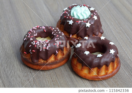 Chocolate coated cakes with decorative topping. Located in the shape of a triangle. Chocolate coated cakes with decorative topping. Located in the shape of a triangle. 115842336
