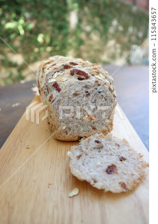 bread , whole wheat bread or sourdough bread or loaf of bread or cranberry and whole grain bread in the tray 115843657