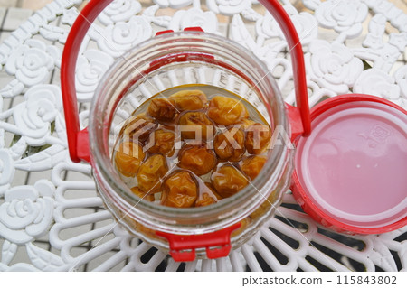 Handmade plum syrup, materials, background 115843802