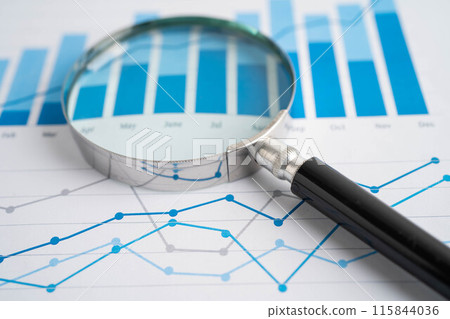 Magnifying glass on graph. Finance business and trading. Magnifying glass on graph. Finance business and trading. 115844036