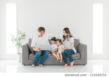 Family looking at a laptop at home Family looking at a laptop at home 115844558