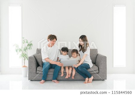 Family looking at a laptop at home Family looking at a laptop at home 115844560