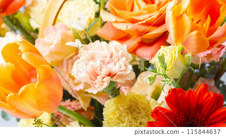 Flowers in wicker basket orange and yellow roses, tulip and carnation isolated on white background 115844637