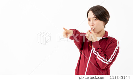 Woman in a jersey blowing a whistle Woman in a jersey blowing a whistle 115845144