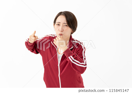 Woman in a jersey blowing a whistle 115845147