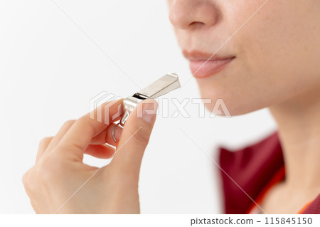 Woman in a jersey blowing a whistle, mouth 115845150